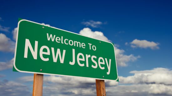 Welcome,To,New,Jersey,Green,Road,Sign,Over,Blue,Sky