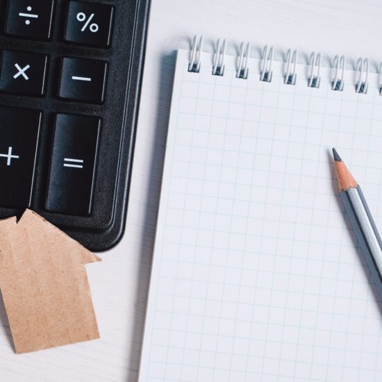 Cardboard,Cutout,House,,Calculator,And,Pencil,On,Blank,Sheet,Of