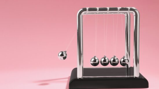 Newton's,Cradle,On,Pink,Background,,Space,For,Text.,Physics,Law